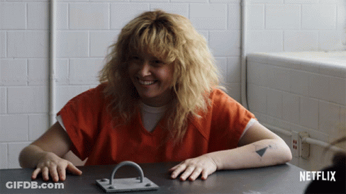 Woman Sitting At Table With Netflix Logo GIF