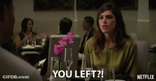 Woman Sitting At Table With Netflix Logo GIF