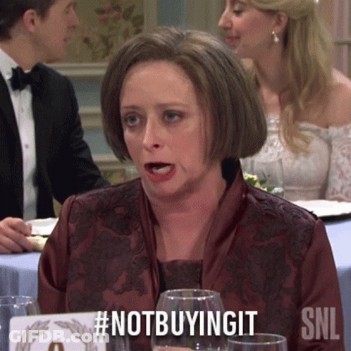 Woman Sitting At Table With #Notbuyingit Sign GIF