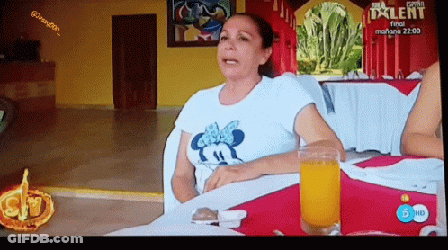 Woman Sitting At Table With Orange Juice GIF