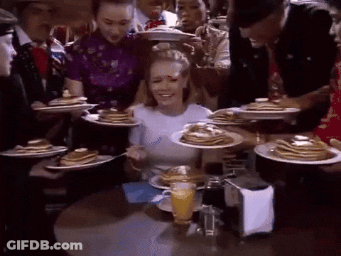 Woman Sitting At Table With Pancakes And Orange Juice GIF