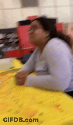 Woman Sitting At Table With Papers GIF