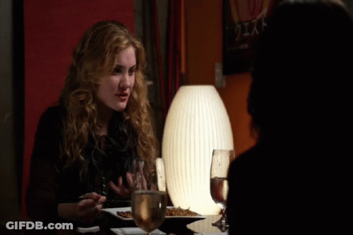 Woman Sitting At Table With Plate Of Food And Glass Of Water GIF