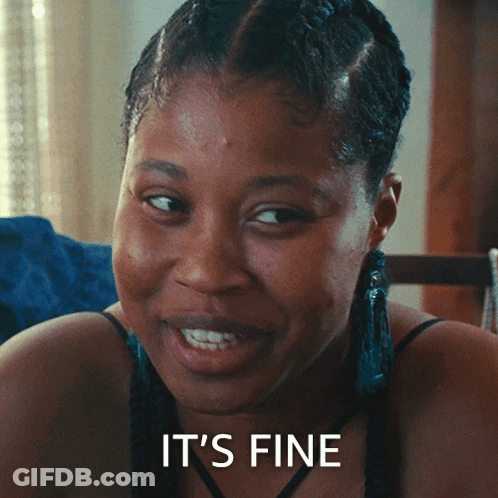 Woman Sitting At Table With Plate, Saying It's Delicious GIF