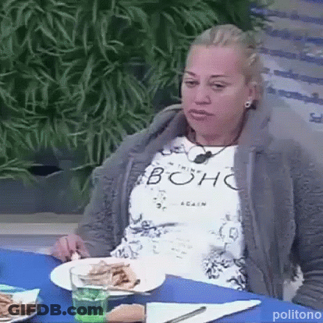 Woman Sitting At Table With Plates Of Food And Water GIF