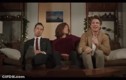 Woman Sitting At Table With Real Housewives Sign GIF