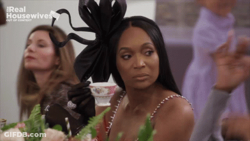 Woman Sitting At Table With Tea Real Housewives GIF