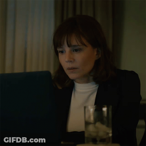 Woman Sitting At Table With Water And Laptop GIF