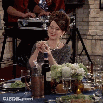 Woman Sitting At Table With Wine GIF