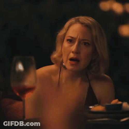 Woman Sitting At Table With Wine GIF