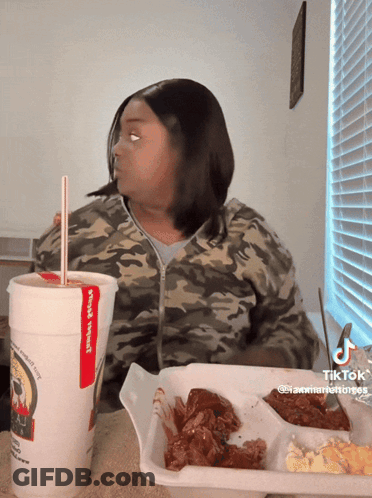 Woman Sitting At Table With Wings Special Cup GIF