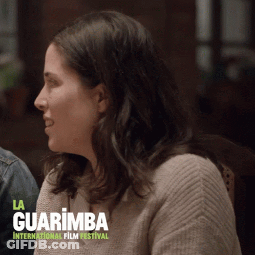 Woman Sitting Before La Guarimba Sign GIF
