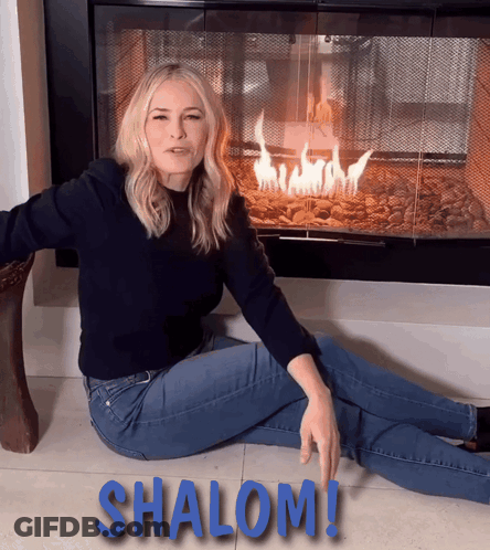 Woman Sitting By Fireplace With Shalom On Floor GIF