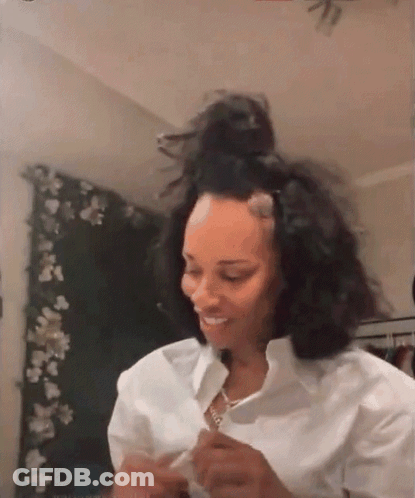 Woman Sitting By Window Wearing Jamaica Shirt GIF