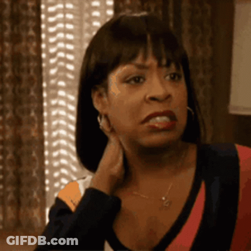 Woman Sitting By Window With Hand On Neck Making Funny Face GIF