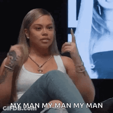 Woman Sitting Cross-Legged Holding Microphone GIF