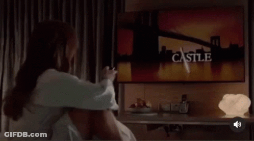Woman Sitting Crossed-Legged On Bed GIF