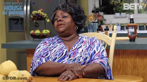 Woman Sitting Eyes Closed At Tyler Perry's House Of Payne Sign GIF