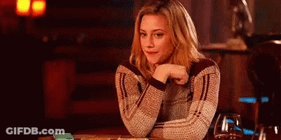 Woman Sitting Hand On Chin Looking At Camera GIF