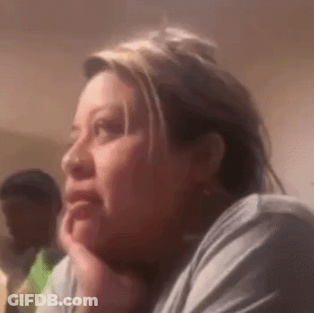Woman Sitting Hand On Chin Looking At Camera GIF