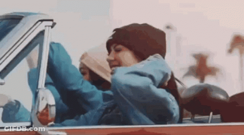 Woman Sitting In Back Seat With Arms Outstretched GIF