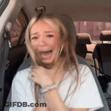 Woman Sitting In Back Seat With Mouth Open GIF