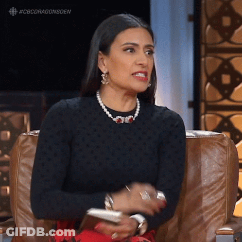 Woman Sitting In Black Sweater And Pearls GIF
