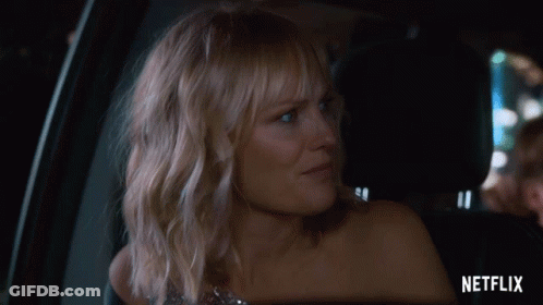 Woman Sitting In Car Back Seat With Netflix Logo GIF