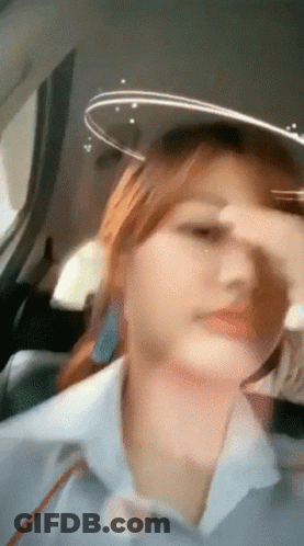 Woman Sitting In Car Covering Nose GIF