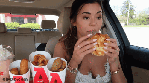 Woman Sitting In Car Eating Hamburger From Bucket Saying AA GIF