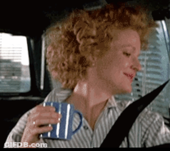 Woman Sitting In Car Holding Blue Mug GIF