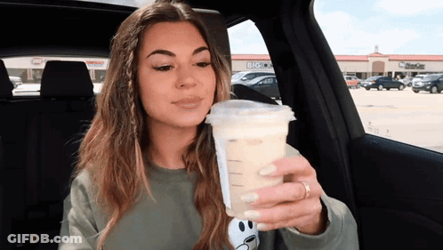 Woman Sitting In Car Holding Coffee GIF