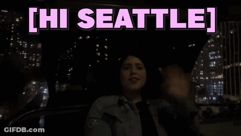 Woman Sitting In Car Saying Hi Seattle GIF