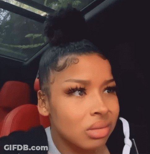 Woman Sitting In Car With Bun On Head GIF