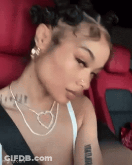 Woman Sitting In Car With Heart Necklace And Earrings GIF