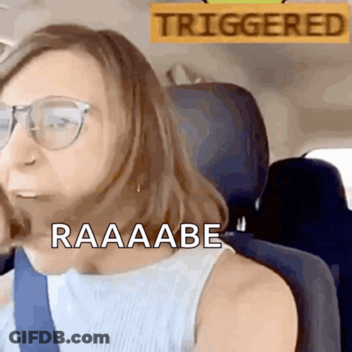Woman Sitting In Car With Triggered Sign GIF