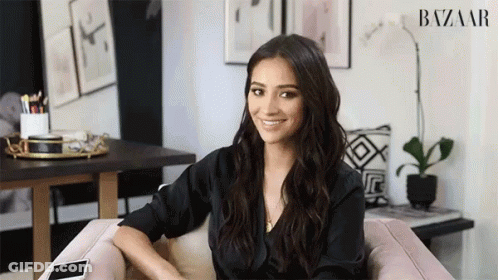 Woman Sitting In Chair Before Harper's Bazaar Ad GIF