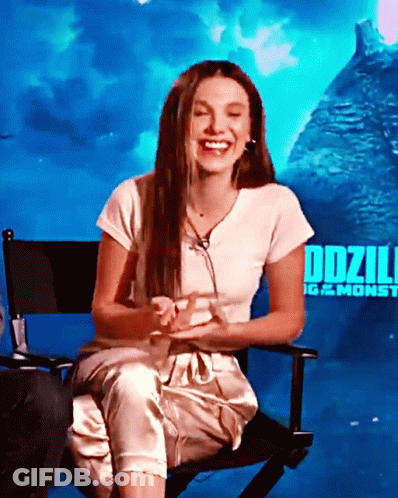Woman Sitting In Chair By Godzilla Poster GIF