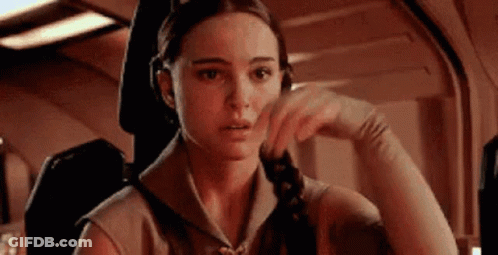 Woman Sitting In Chair Hand On Chin Looking At Camera GIF