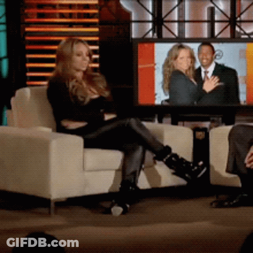 Woman Sitting In Chair In Front Of Television Screen GIF