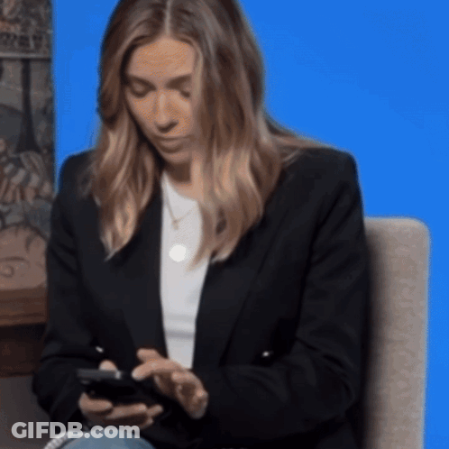 Woman Sitting In Chair Looking At Phone GIF