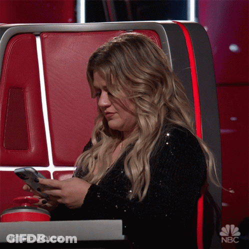 Woman Sitting In Chair Looking At Phone #TheVoice GIF