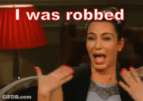 Woman Sitting In Chair Mouth Open Saying I Was Robbed GIF