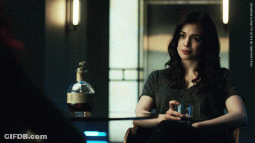 Woman Sitting In Chair Next To Whiskey GIF