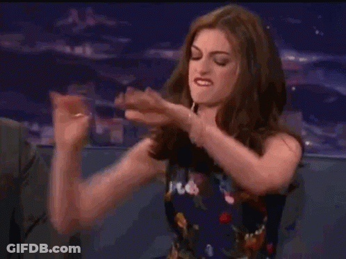 Woman Sitting In Chair Pointing GIF
