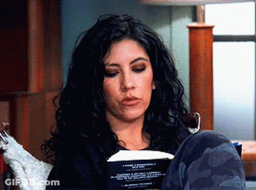 Woman Sitting In Chair Reading Book Legs Crossed GIF
