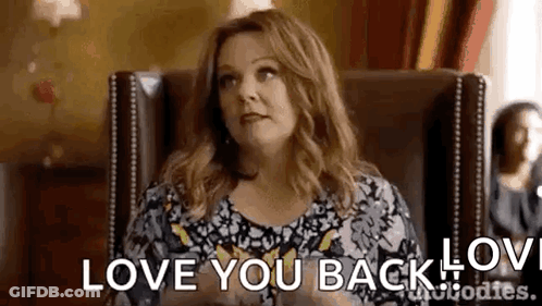 Woman Sitting In Chair Saying Love You Back GIF