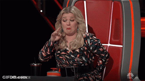 Woman Sitting In Chair Saying The Voice GIF