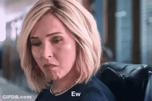 Woman Sitting In Chair With Eyes Closed Making Face GIF