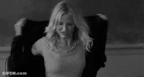 Woman Sitting In Chair With Hair Blowing In Wind GIF